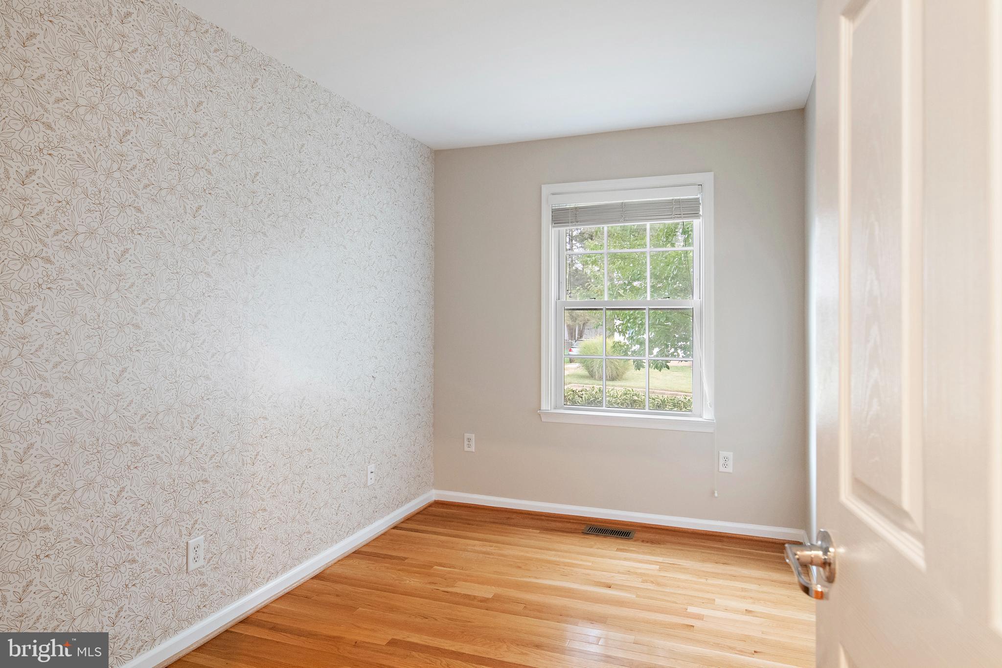 129 Gibson Road Annapolis, MD 21401 - Photo 30 of 50 a view of an empty room with wooden floor and a window