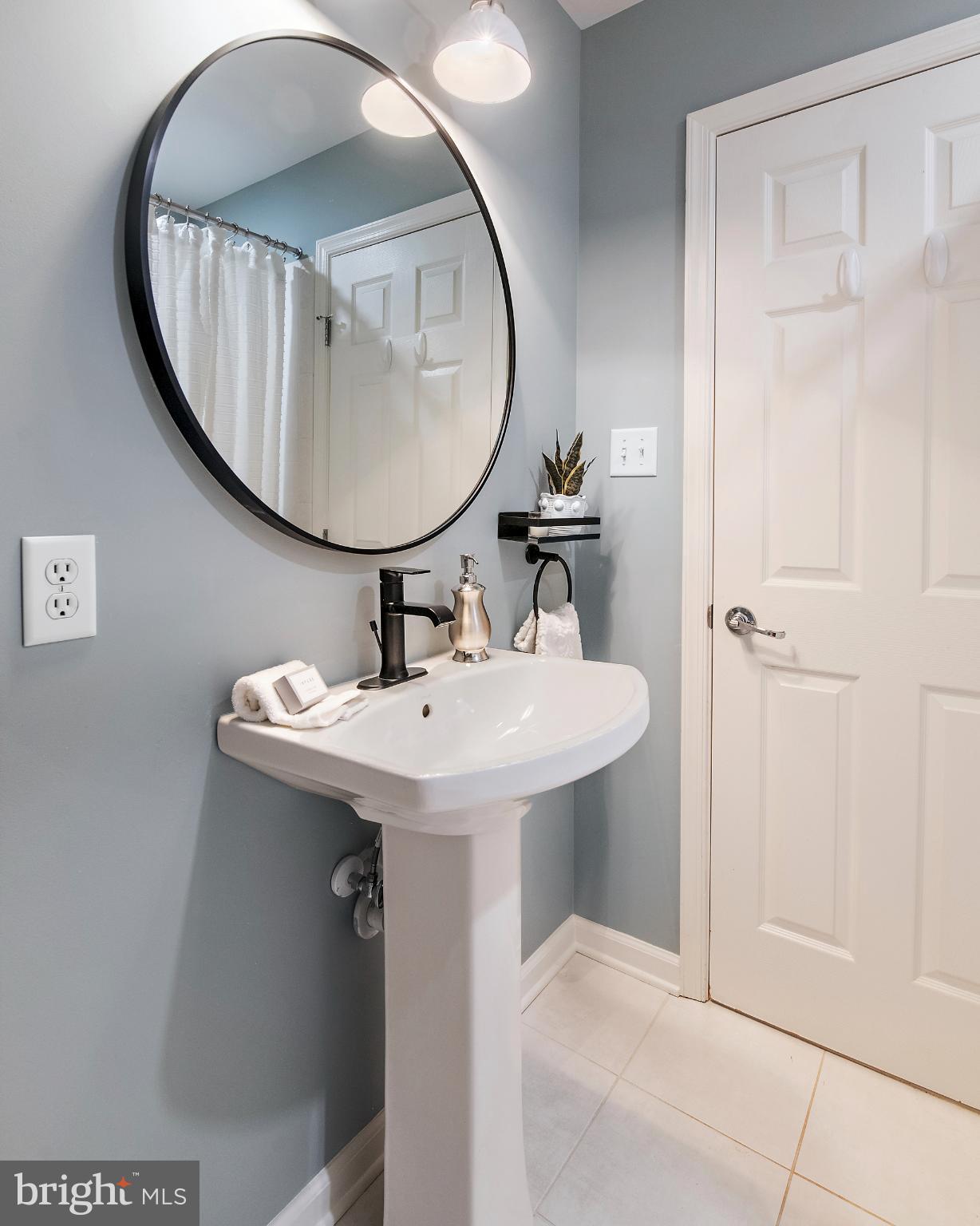 129 Gibson Road Annapolis, MD 21401 - Photo 32 of 50 a bathroom with a sink a mirror a vanity and a shower