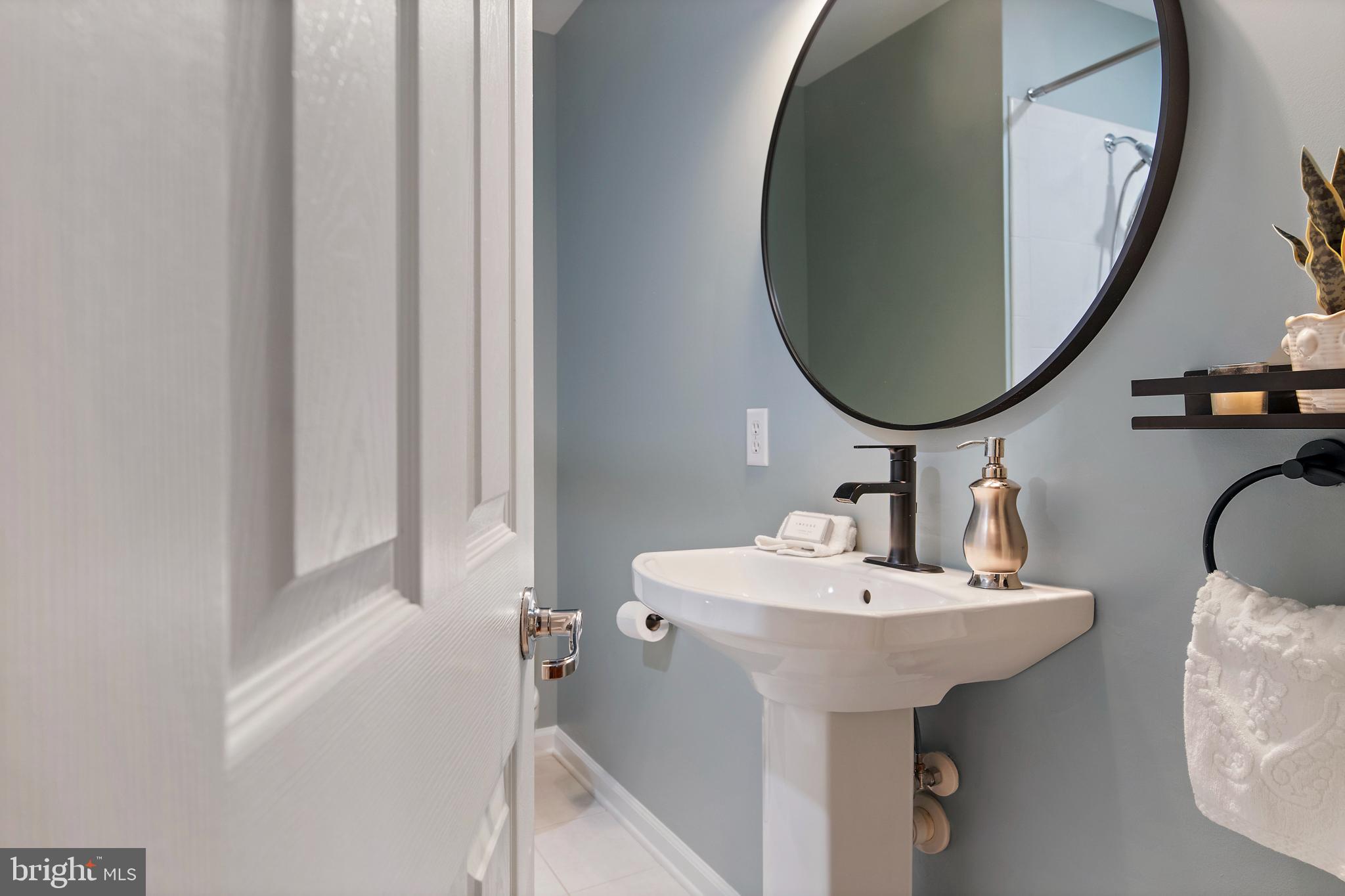 129 Gibson Road Annapolis, MD 21401 - Photo 33 of 50 a bathroom with a sink and a mirror