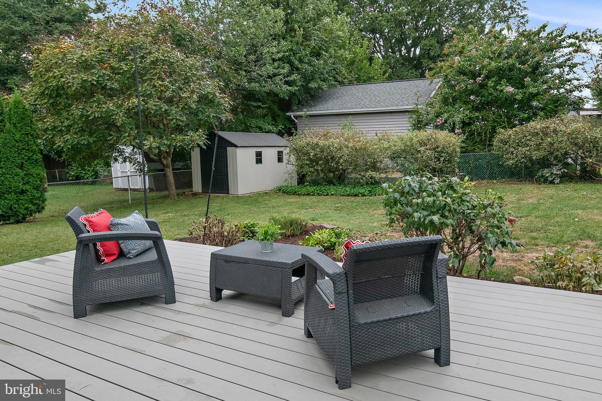 129 Gibson Road Annapolis, MD 21401 - Photo 43 of 50 a view of a wooden chair and fire pit in the back yard of a house
