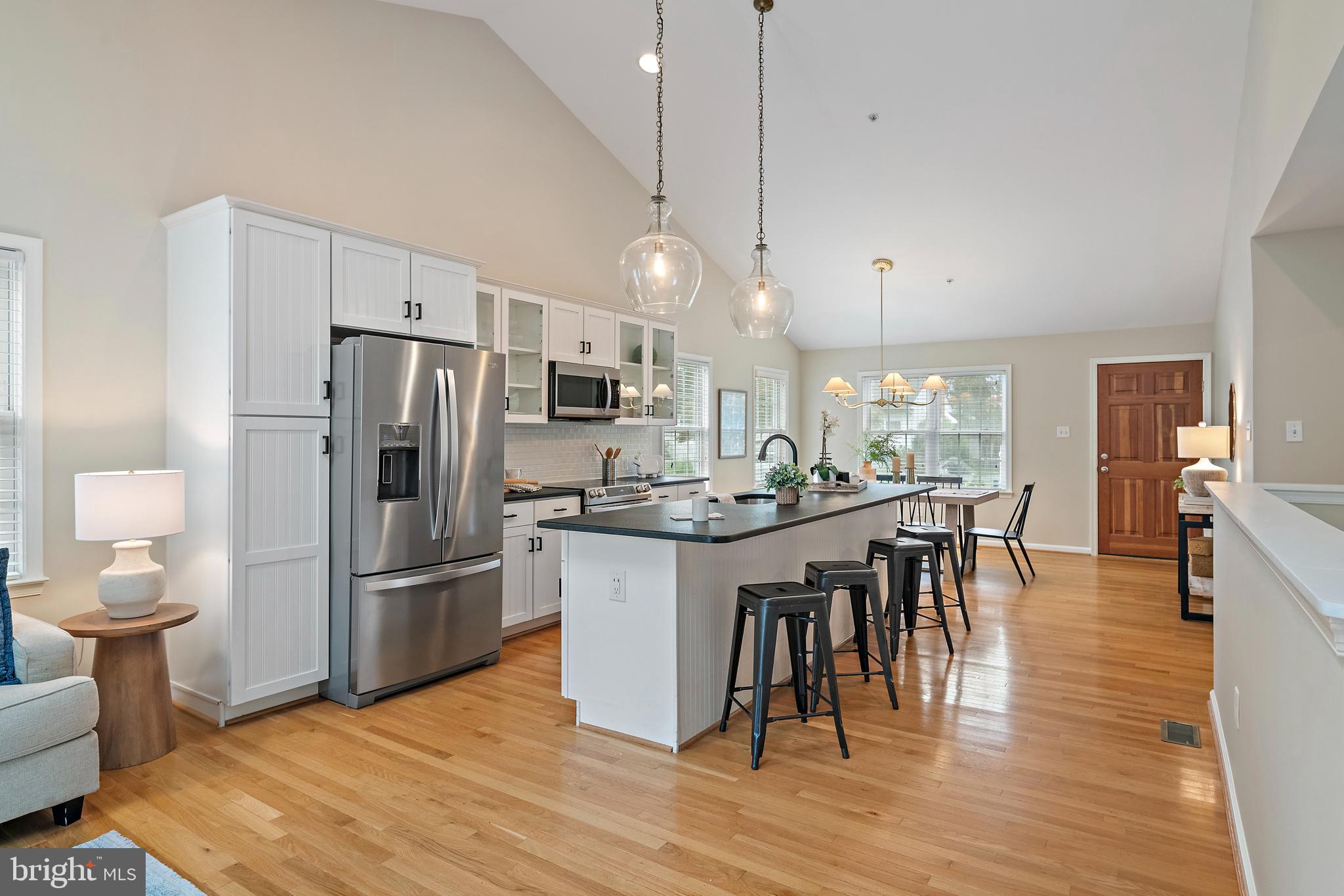 129 Gibson Road Annapolis, MD 21401 - Photo 5 of 50 a kitchen with stainless steel appliances a refrigerator a stove a sink dishwasher and a dining table with wooden floor
