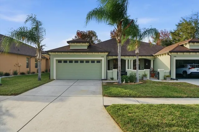 a front view of a house with a yard and garage