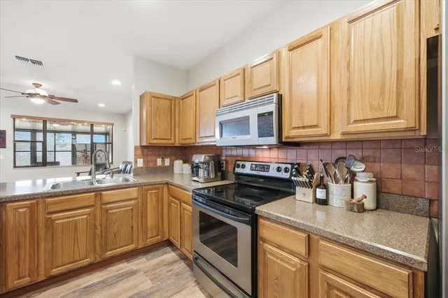 a view of a room with gym equipment and a chandelier