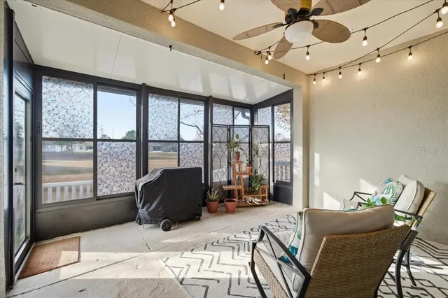 a workspace with furniture and floor to ceiling window