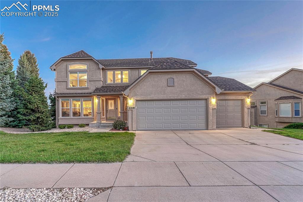 5514 Saxon Lane Colorado Springs, CO 80918 - Photo 1 of 50 a front view of a house with a yard and garage