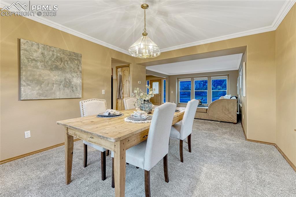5514 Saxon Lane Colorado Springs, CO 80918 - Photo 14 of 50 a view of a dining room with furniture and a chandelier
