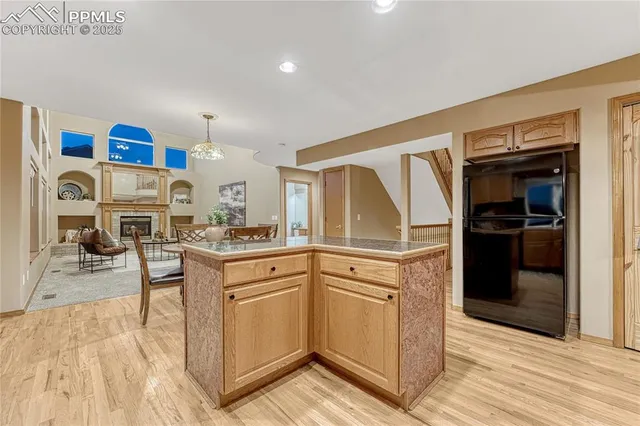 a kitchen with stainless steel appliances granite countertop a refrigerator and a stove top oven