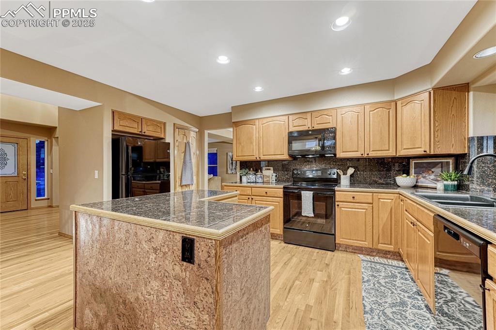 5514 Saxon Lane Colorado Springs, CO 80918 - Photo 18 of 50 a kitchen with stainless steel appliances granite countertop a stove and a sink