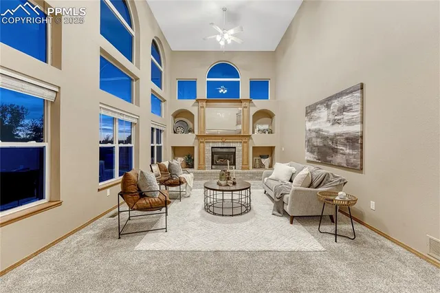 a living room with fireplace furniture and a fireplace