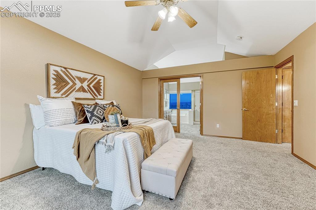 5514 Saxon Lane Colorado Springs, CO 80918 - Photo 24 of 50 a bed room with a bed and a chandelier