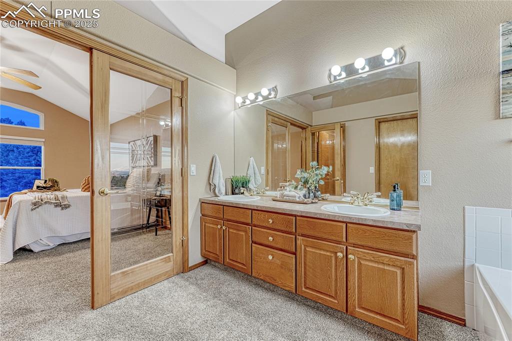 5514 Saxon Lane Colorado Springs, CO 80918 - Photo 27 of 50 a spacious bathroom with a granite countertop sink a mirror and a bathtub