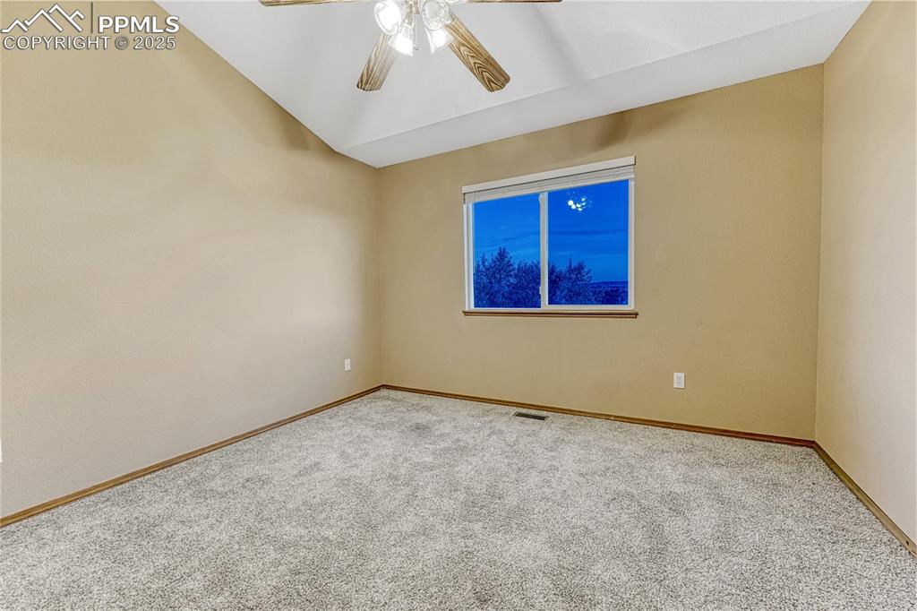 5514 Saxon Lane Colorado Springs, CO 80918 - Photo 29 of 50 an empty room with a ceiling fan and a window