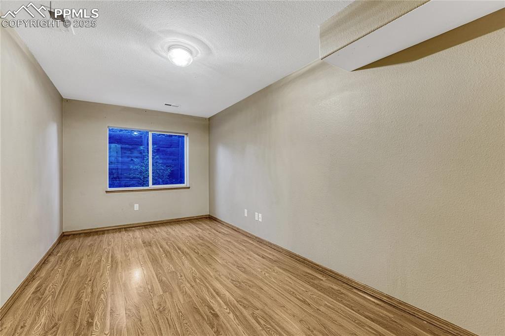 5514 Saxon Lane Colorado Springs, CO 80918 - Photo 33 of 50 a view of an empty room with wooden floor and a window