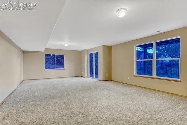 an empty room with furniture and window