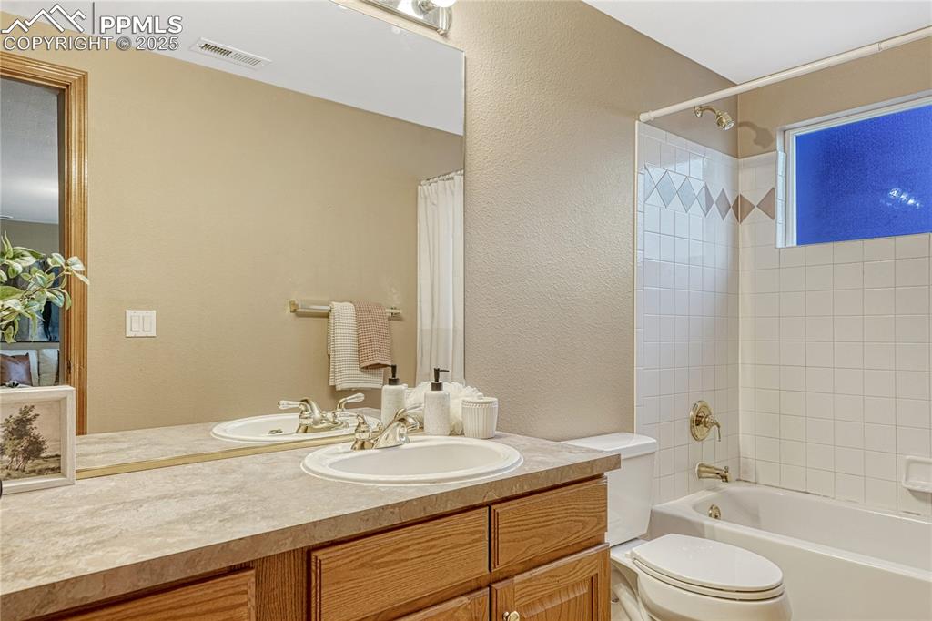 5514 Saxon Lane Colorado Springs, CO 80918 - Photo 43 of 50 a bathroom with a granite countertop sink toilet and shower