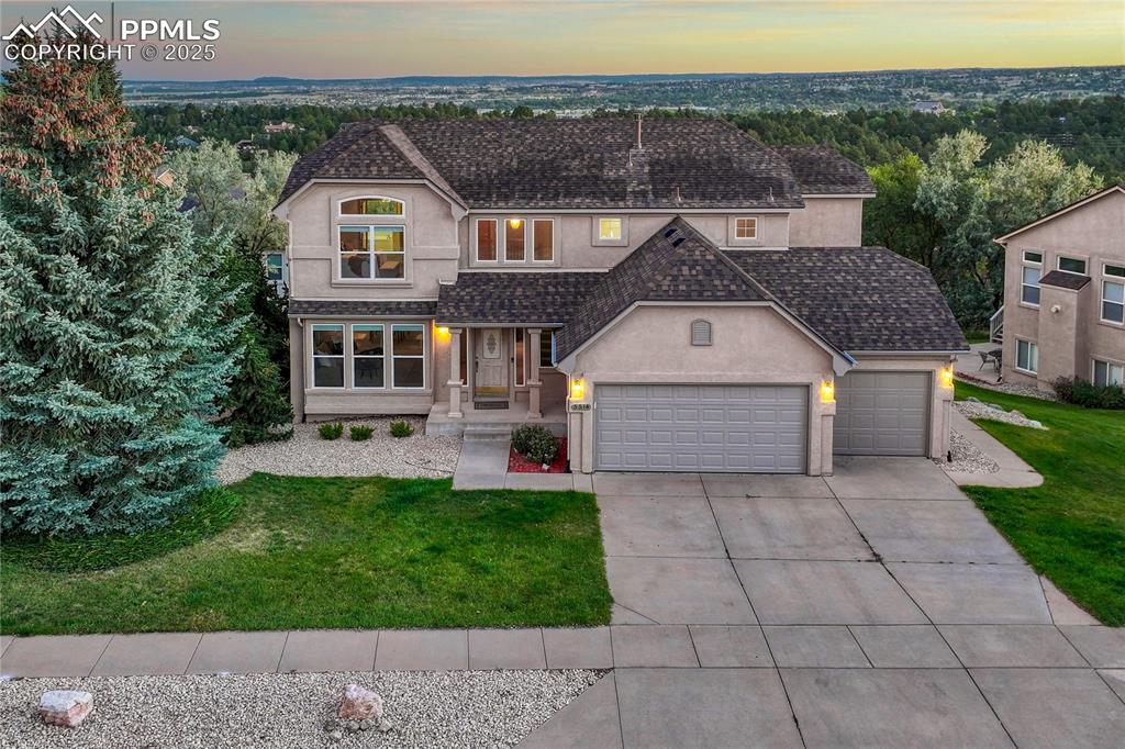 5514 Saxon Lane Colorado Springs, CO 80918 - Photo 5 of 50 a front view of a house with a yard and garage