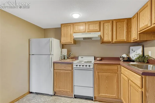 a kitchen with a stove a sink and a refrigerator