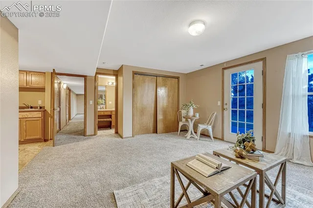 a living room with furniture a dining table and chairs with kitchen view