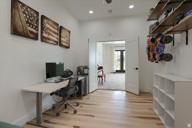 828 South Deer Road Tooele, UT 84074 - Photo 27 of 51 Hardwood-style flooring with bright white walls, recessed lighting, and a doorway leading to an additional space with double doors