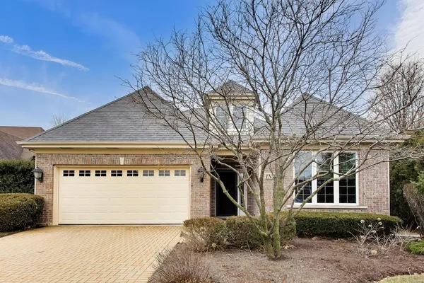 a view of a house with a yard and garage