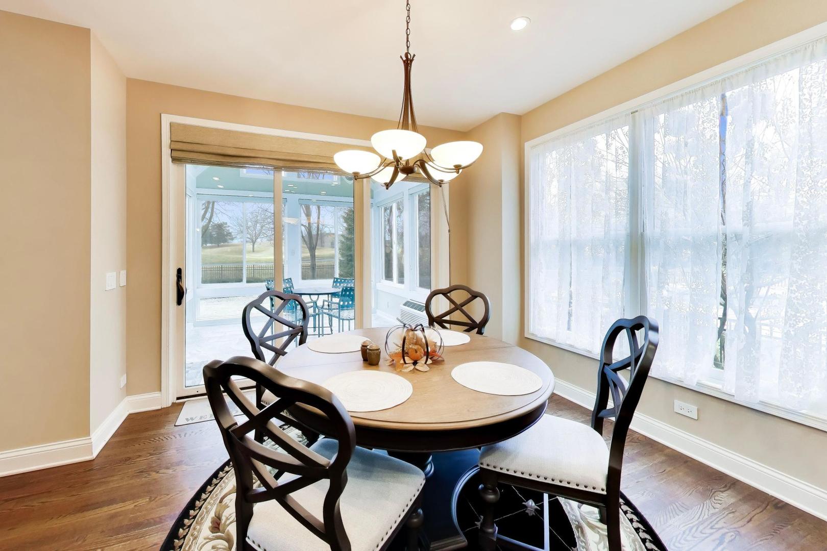 1N598 Golf View Lane Winfield, IL 60190 - Photo 12 of 33 a view of a dining room with furniture window and wooden floor
