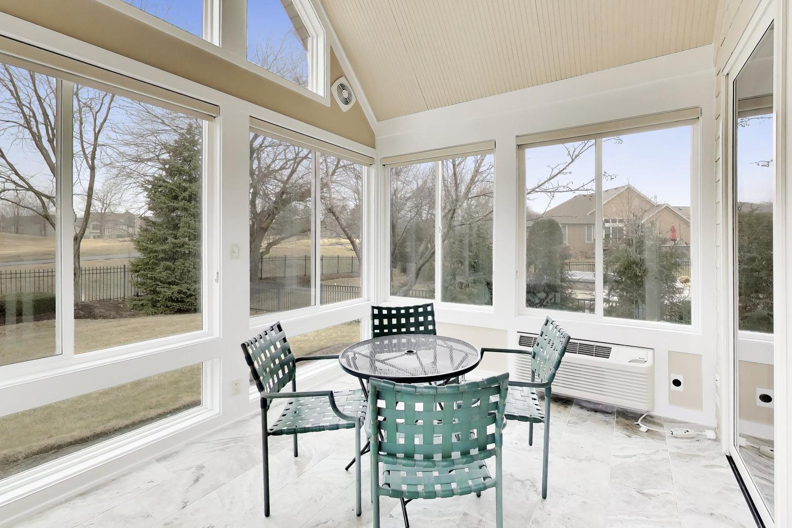 1N598 Golf View Lane Winfield, IL 60190 - Photo 14 of 33 a view of a dining room with furniture large windows and wooden floor
