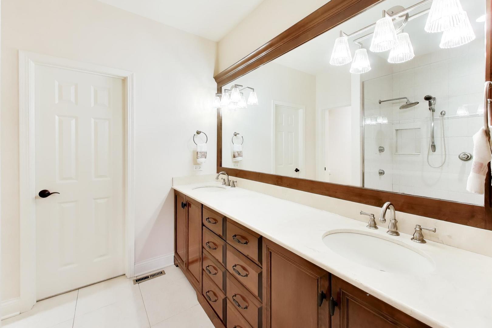 1N598 Golf View Lane Winfield, IL 60190 - Photo 18 of 33 a bathroom with a double vanity sink and mirror