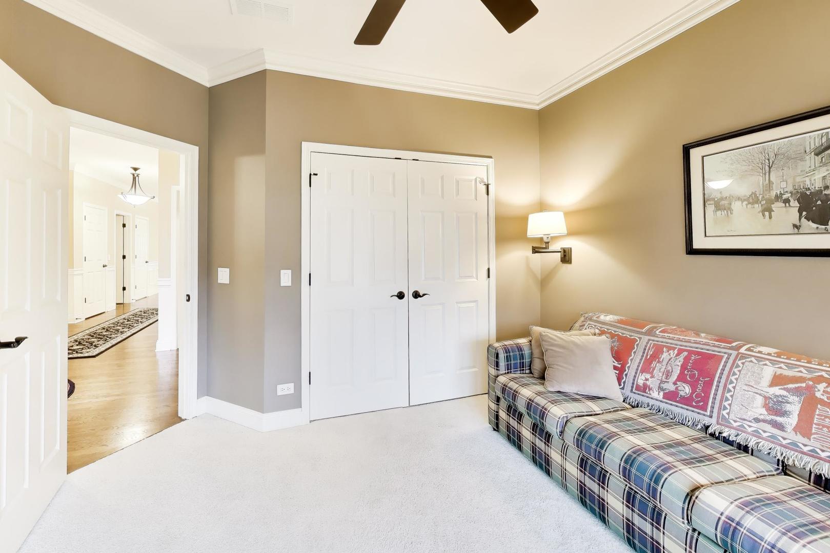1N598 Golf View Lane Winfield, IL 60190 - Photo 22 of 33 a bedroom with a bed and a couch