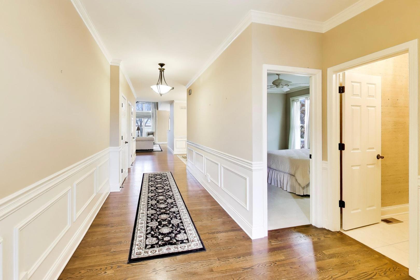 1N598 Golf View Lane Winfield, IL 60190 - Photo 3 of 33 a view of a hallway with wooden floor and a bathroom