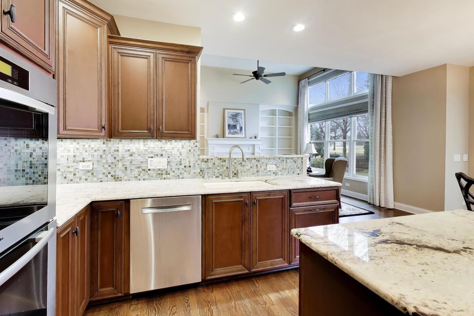 1N598 Golf View Lane Winfield, IL 60190 - Photo 10 of 33 a kitchen with stainless steel appliances granite countertop wooden cabinets a sink and dishwasher