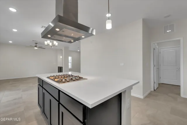 a kitchen that has a stove a table and chairs in it