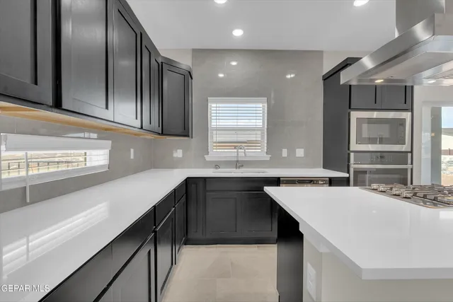 a kitchen with a stove a sink and a refrigerator