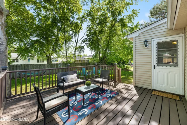 a sitting area with furniture on wooden deck