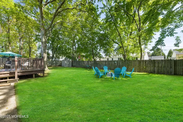 a view of backyard with table and chairs and a slide