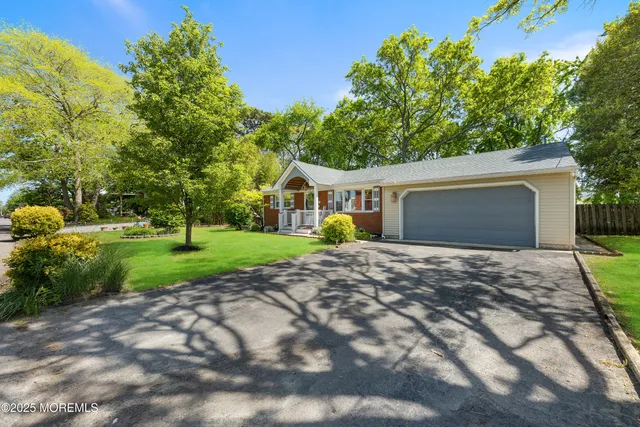 a view of an house with backyard space and tree