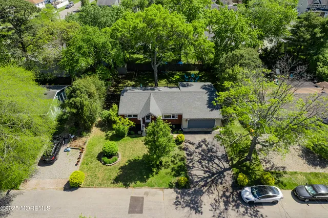 an aerial view of a house with yard swimming pool and outdoor seating