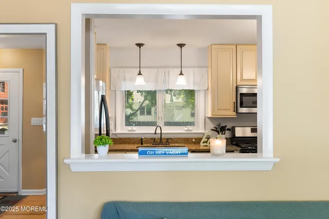 a kitchen with stainless steel appliances a sink and a window
