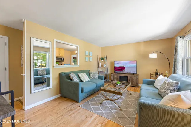a living room with fireplace furniture and a floor to ceiling window