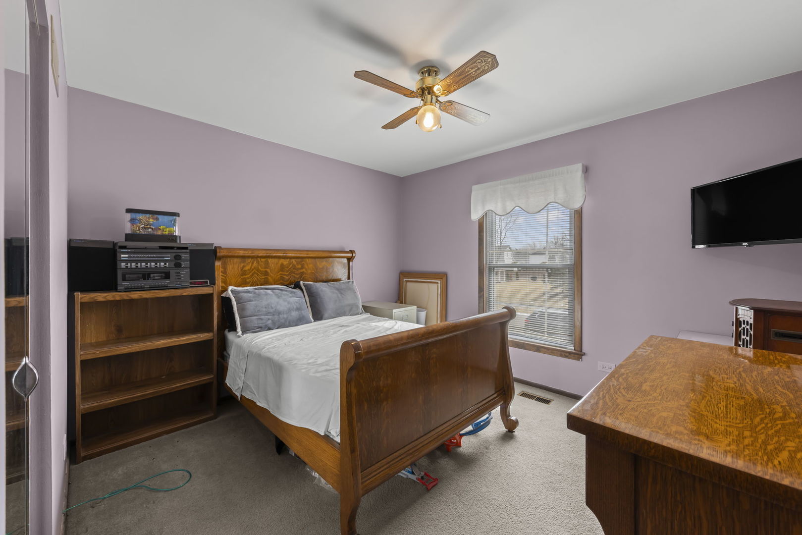 580 Whitehall Way Bolingbrook, IL 60440 - Photo 13 of 25 a bedroom with a bed and a flat screen tv