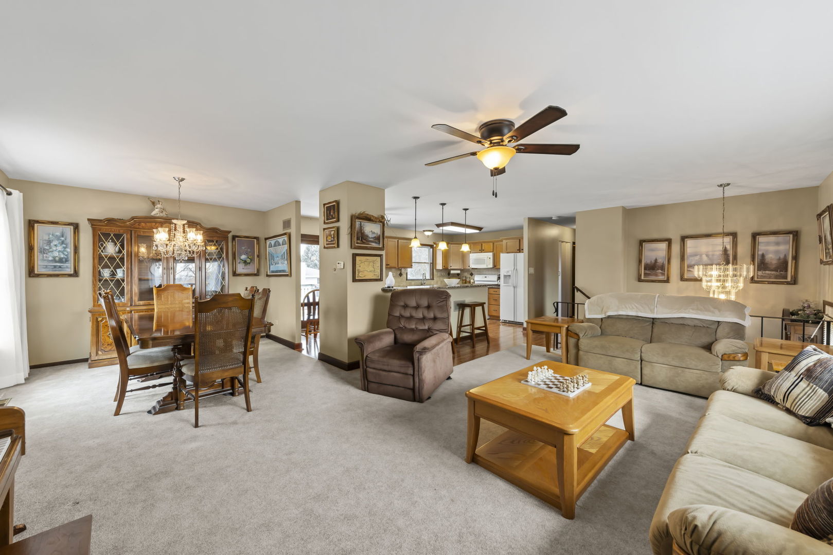 580 Whitehall Way Bolingbrook, IL 60440 - Photo 5 of 25 a living room with furniture a fireplace and a chandelier
