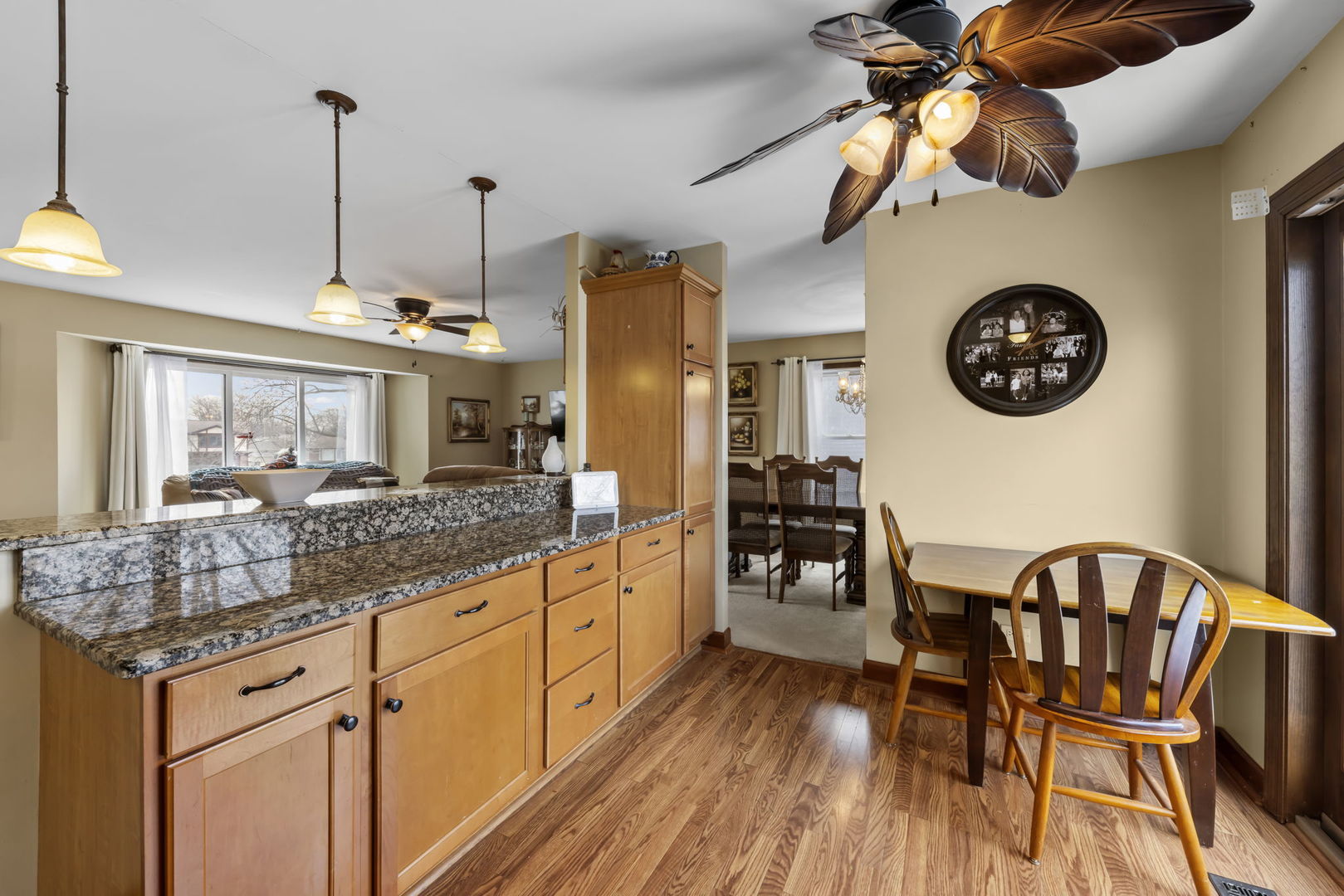 580 Whitehall Way Bolingbrook, IL 60440 - Photo 8 of 25 a kitchen with stainless steel appliances granite countertop a stove a refrigerator a dining table and chairs with wooden floor