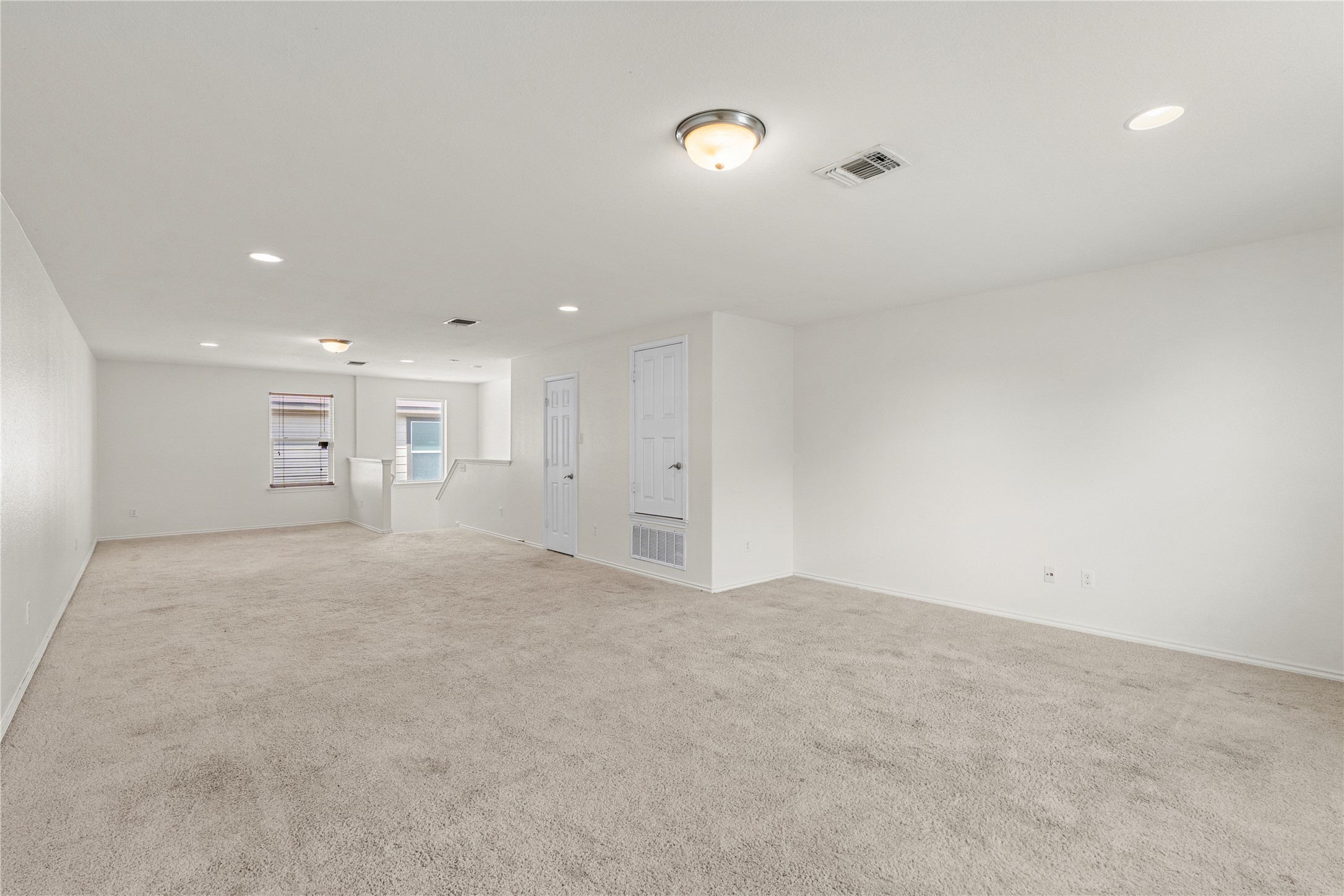 8613 Capitol View Drive Austin, TX 78747 - Photo 26 of 33 A spacious, neutral loft with plush carpeting and ample natural light invites relaxation.