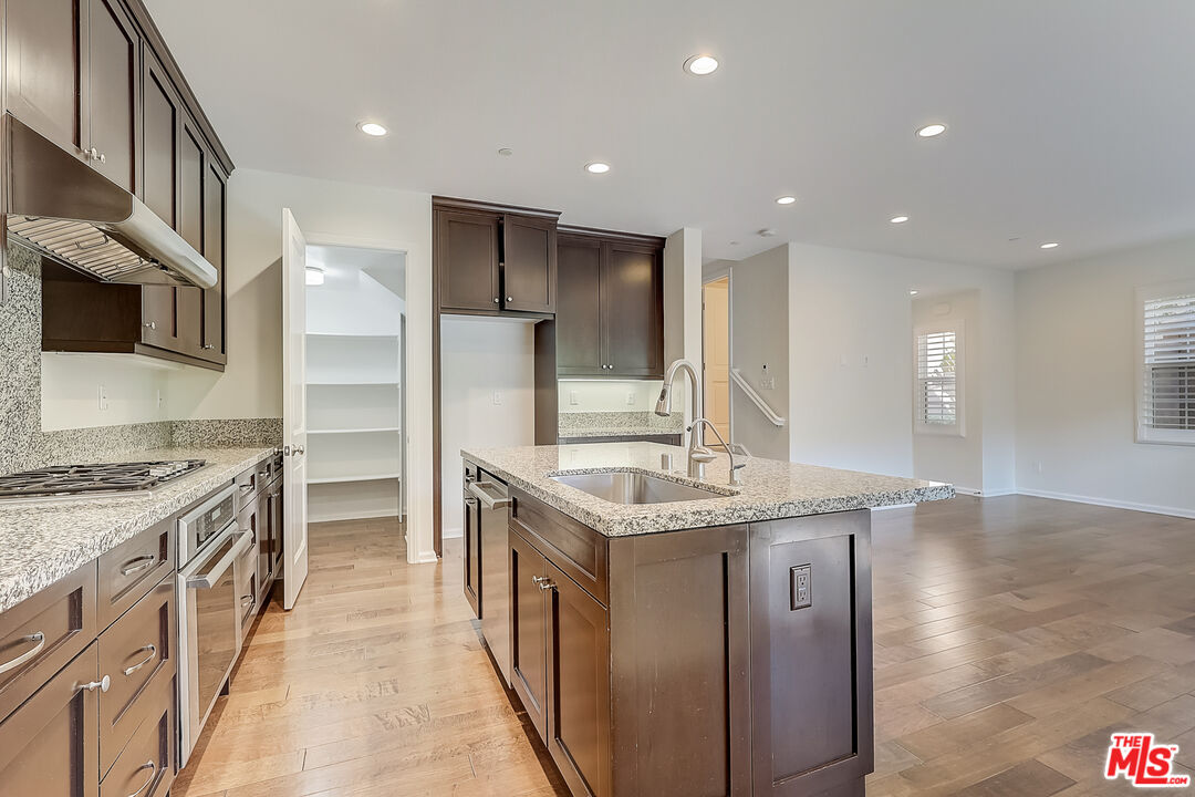 130 Firefly Irvine, CA 92618 - Photo 11 of 29 a kitchen with stainless steel appliances granite countertop a kitchen island a stove and a refrigerator
