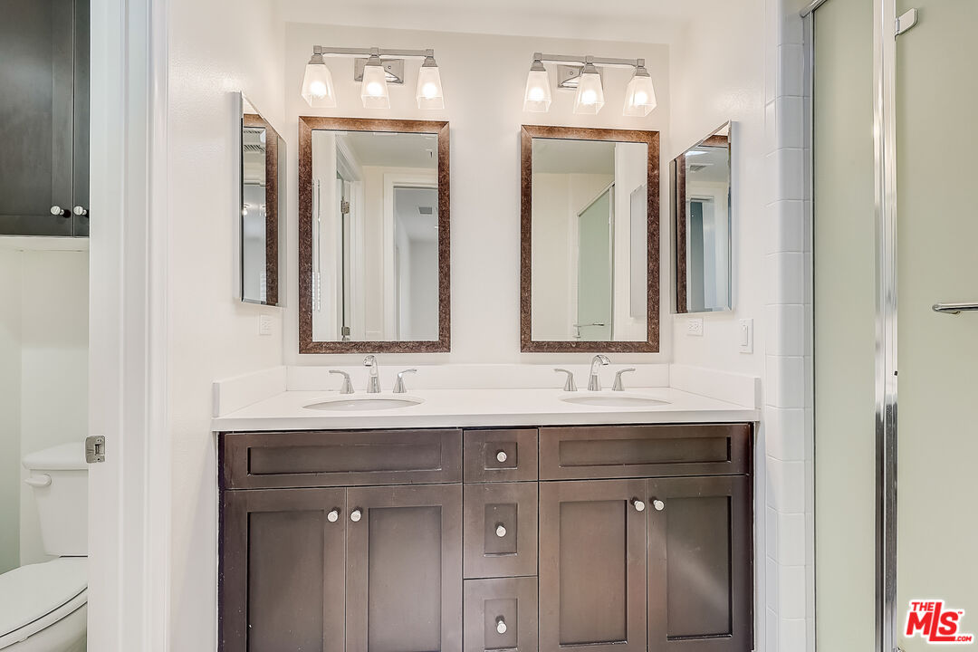 130 Firefly Irvine, CA 92618 - Photo 14 of 29 a bathroom with double sink and a mirror