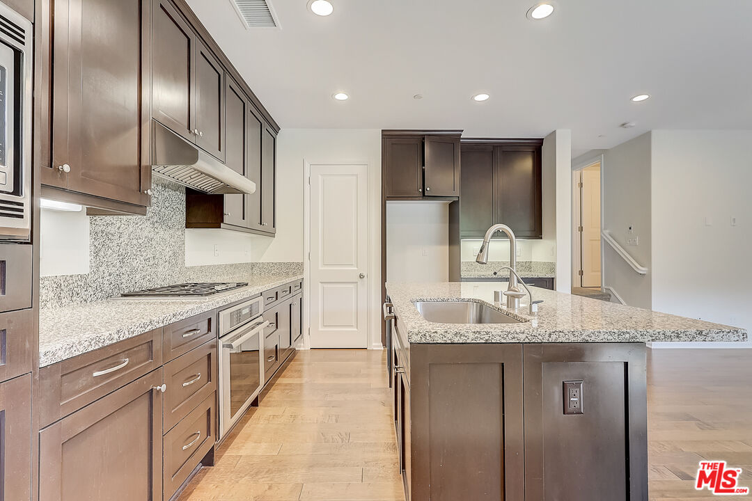 130 Firefly Irvine, CA 92618 - Photo 4 of 29 a large kitchen with stainless steel appliances granite countertop a lot of counter space and a sink