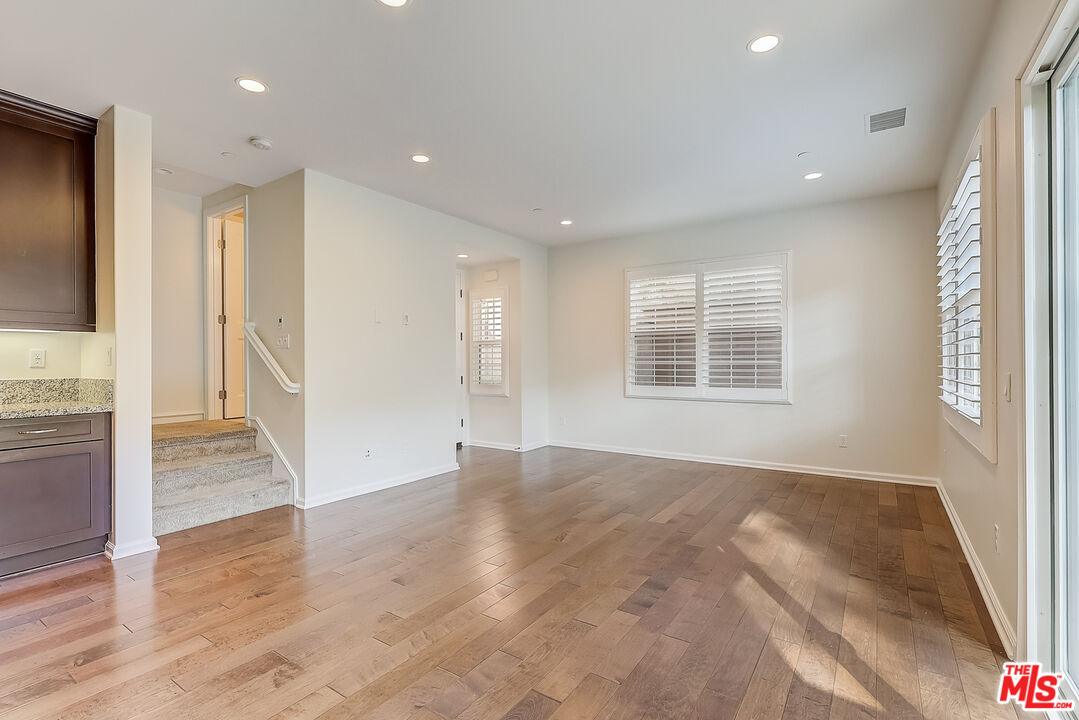 130 Firefly Irvine, CA 92618 - Photo 5 of 29 a view of an empty room with wooden floor and a window