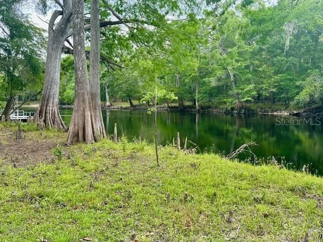 a view of a lake with a house in the background