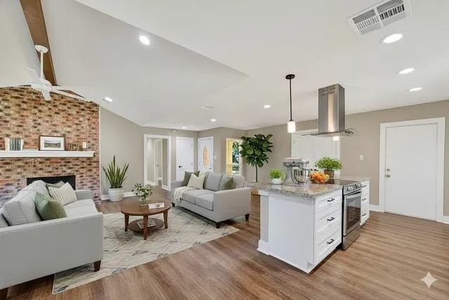 a living room with furniture and wooden floor