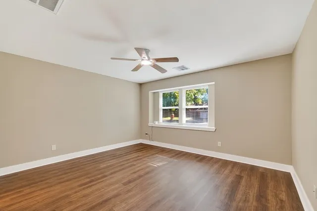 wooden floor in an empty room with a window