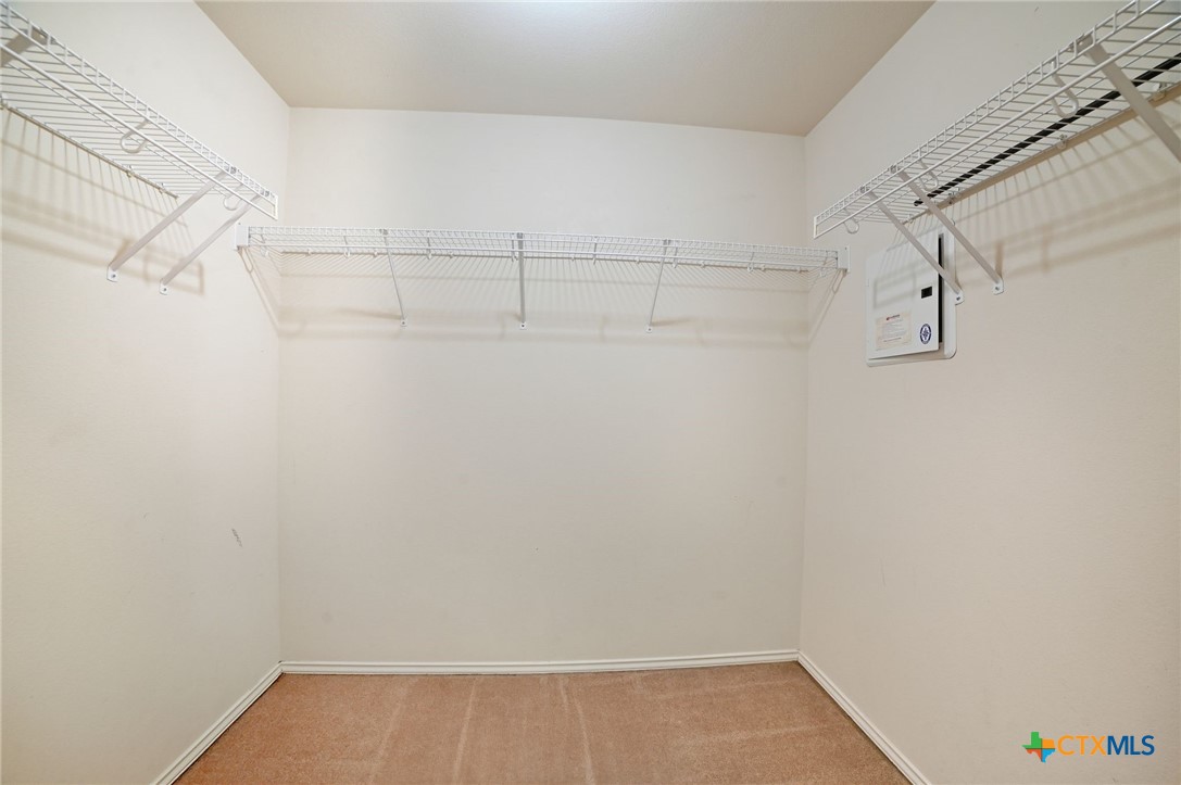 316 Housefinch Loop Leander, TX 78641 - Photo 22 of 37 Primary Bedroom #1 Walk-in closet with shelving and plenty of hanging space.